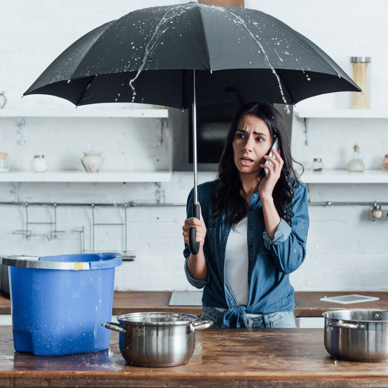 upset woman standing under umbrella in kitchen and 2023 11 27 05 36 47 utc copy